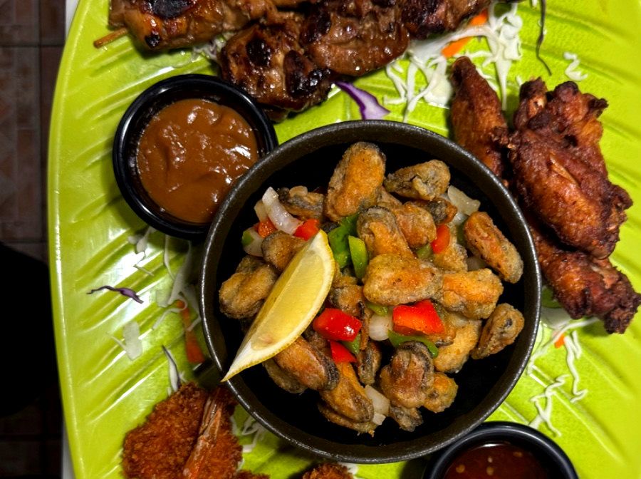 Aziana snack platter with chicken satay, crispy bites and house dipping sauces