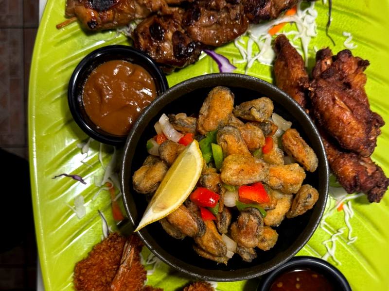 Aziana snack platter with chicken satay, crispy bites and house dipping sauces