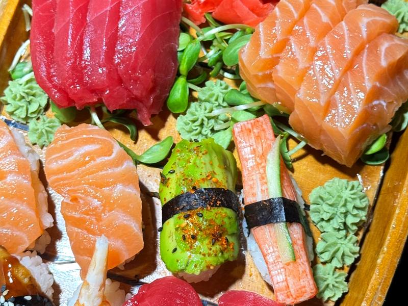 Sushi and sashimi combination boat with tuna, salmon, shrimp and maki rolls